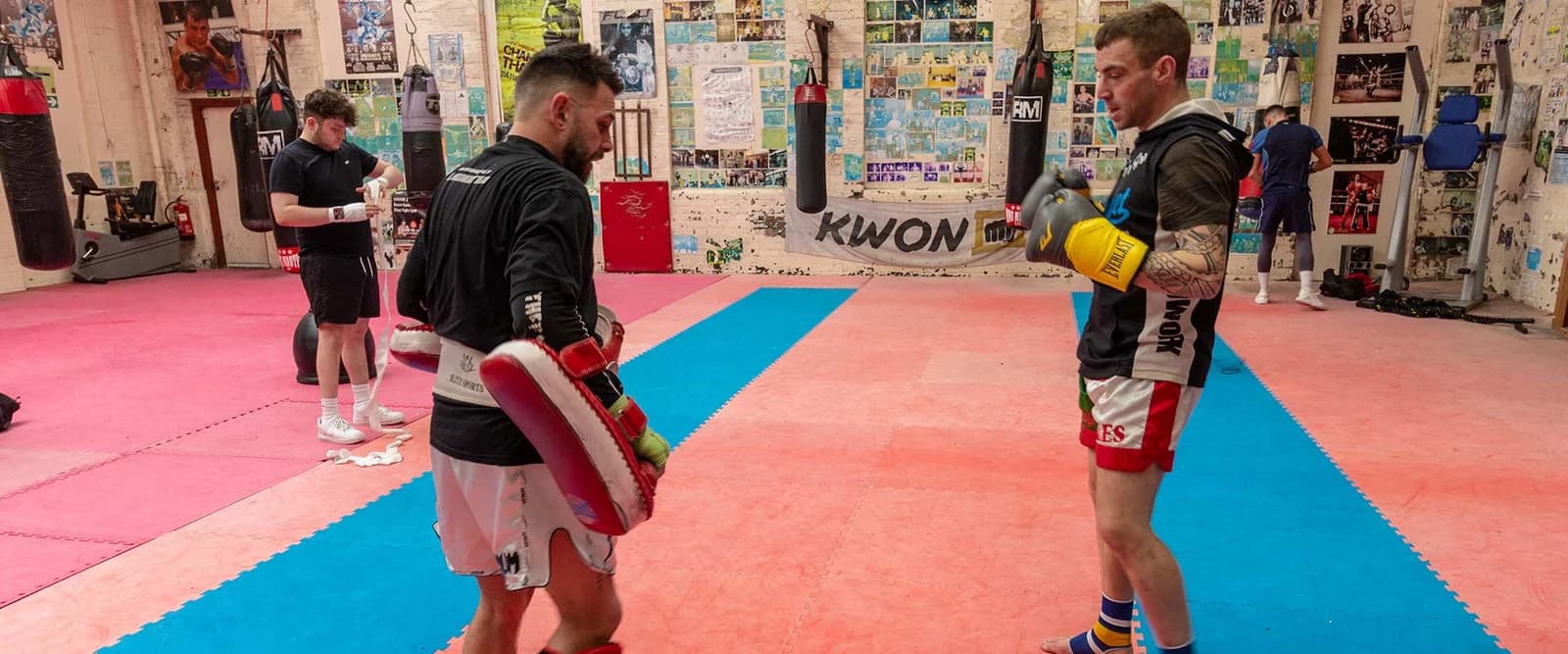 Muay Thai pad work on the UFCC training floor