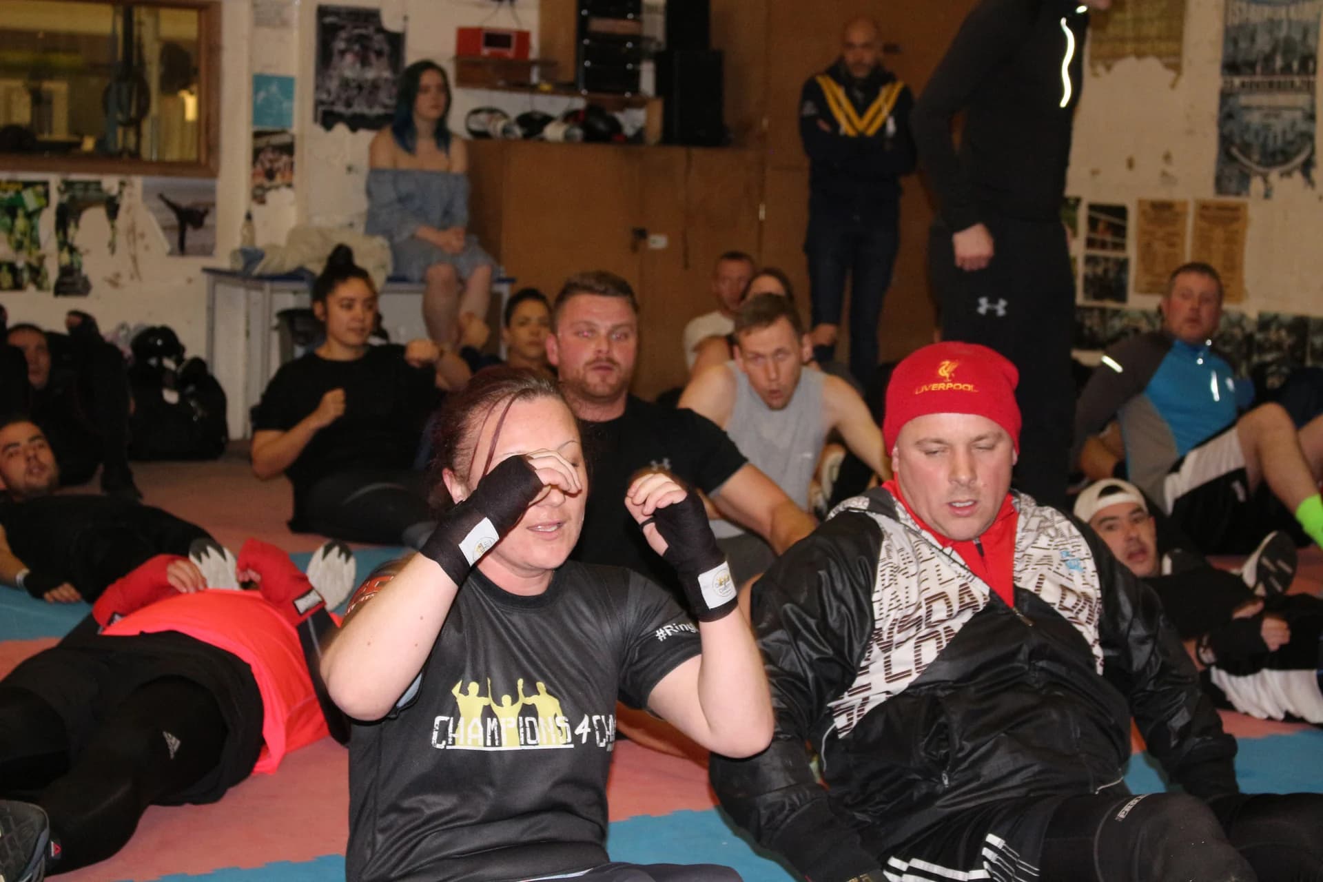 Participants practising seated boxing drills during a group session at UFCC