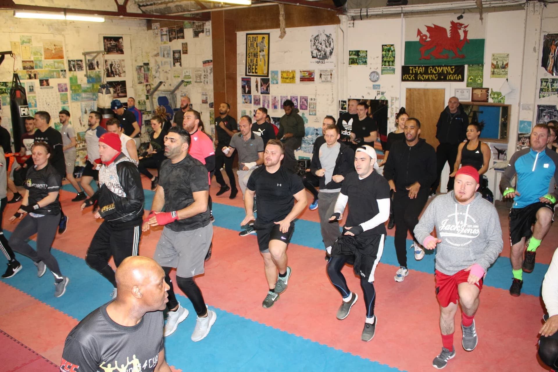 A boxing group warming up with high knees at UFCC