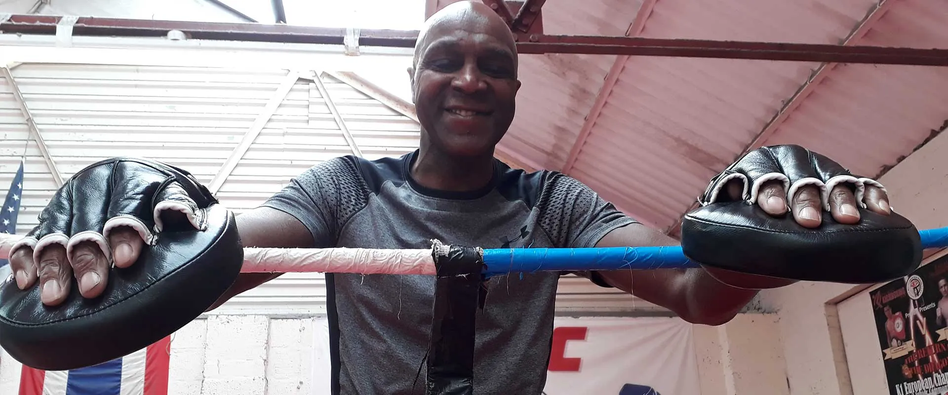 Denzil Lawrence with his training mitts in the UFCC ring